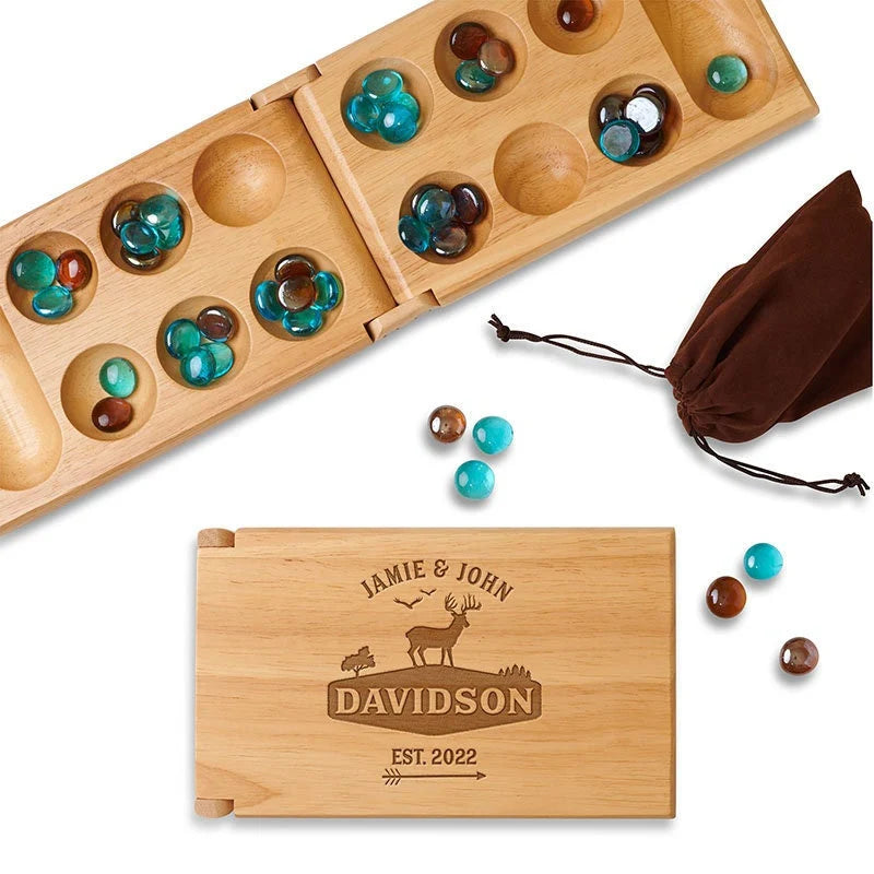 Mancala game set engraved with the image of a deer in the woods.