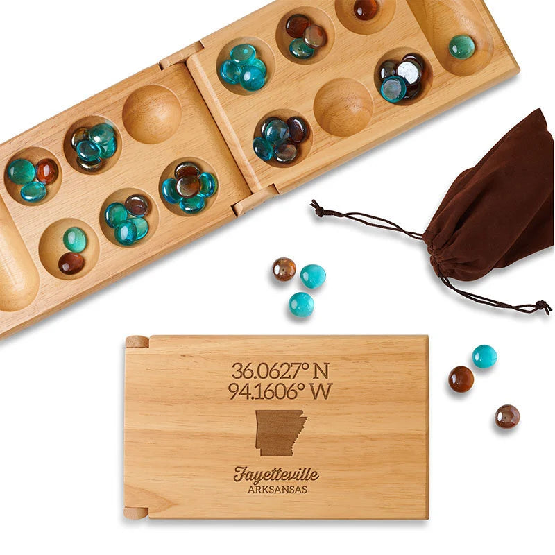 Wooden mancala game set folded with latitude and longitude coordinates engraved above the image of shape of Arkansas.
