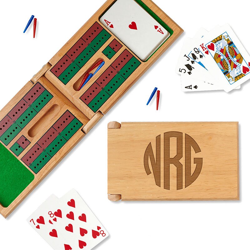 Wood cribbage board engraved with three initials in a round design. 